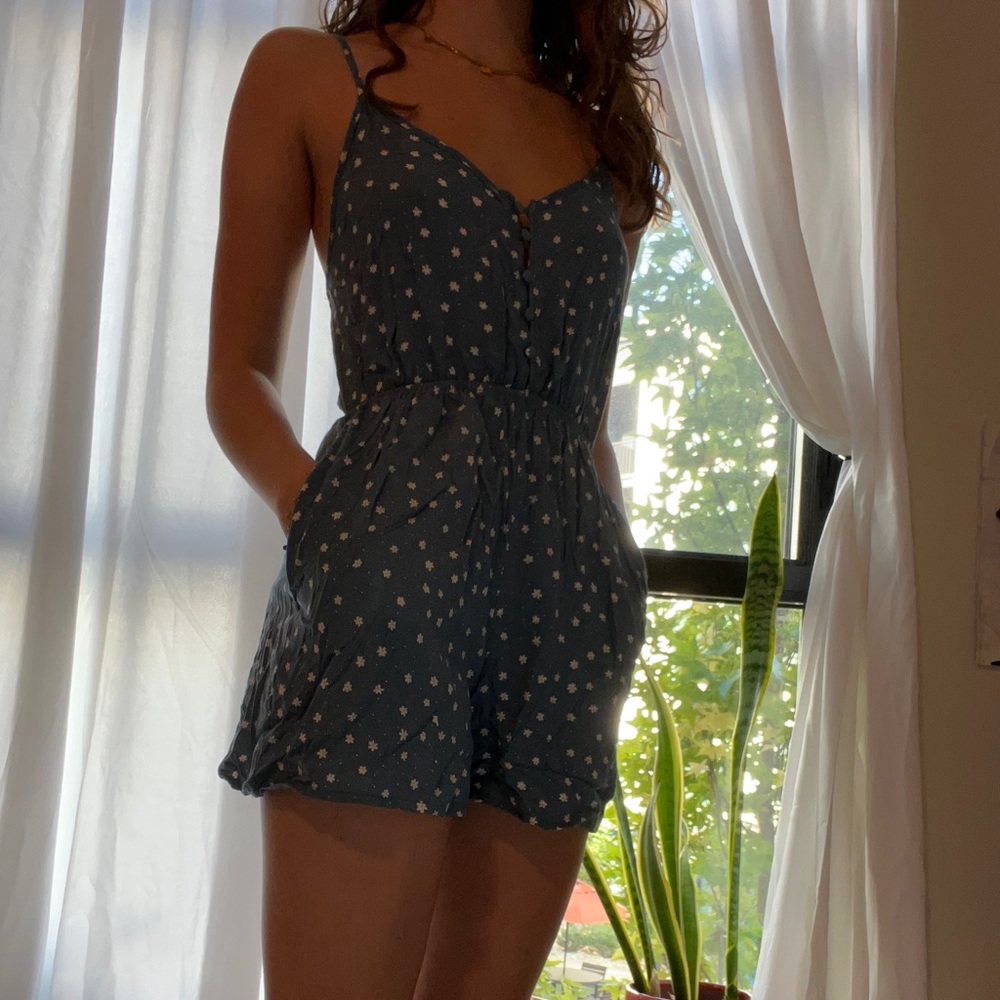 light blue romper with white daisies and petit buttons